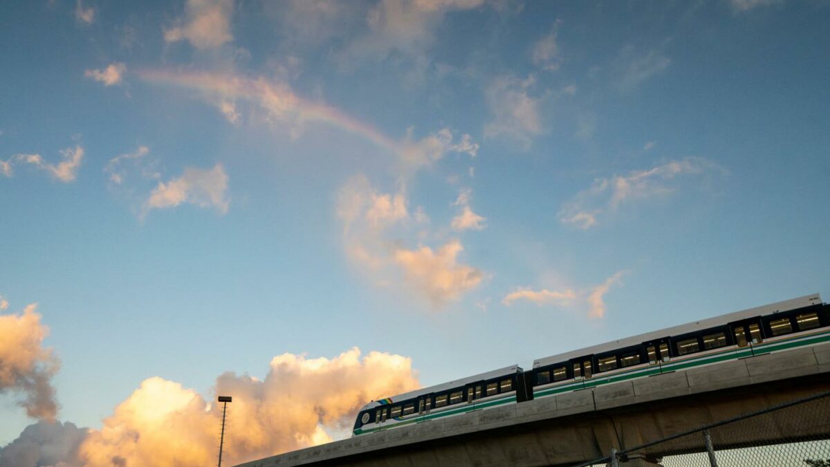 A rainbow arches over a Honolulu Skyline train at sunset, Sept. 19, 2024, in Honolulu.